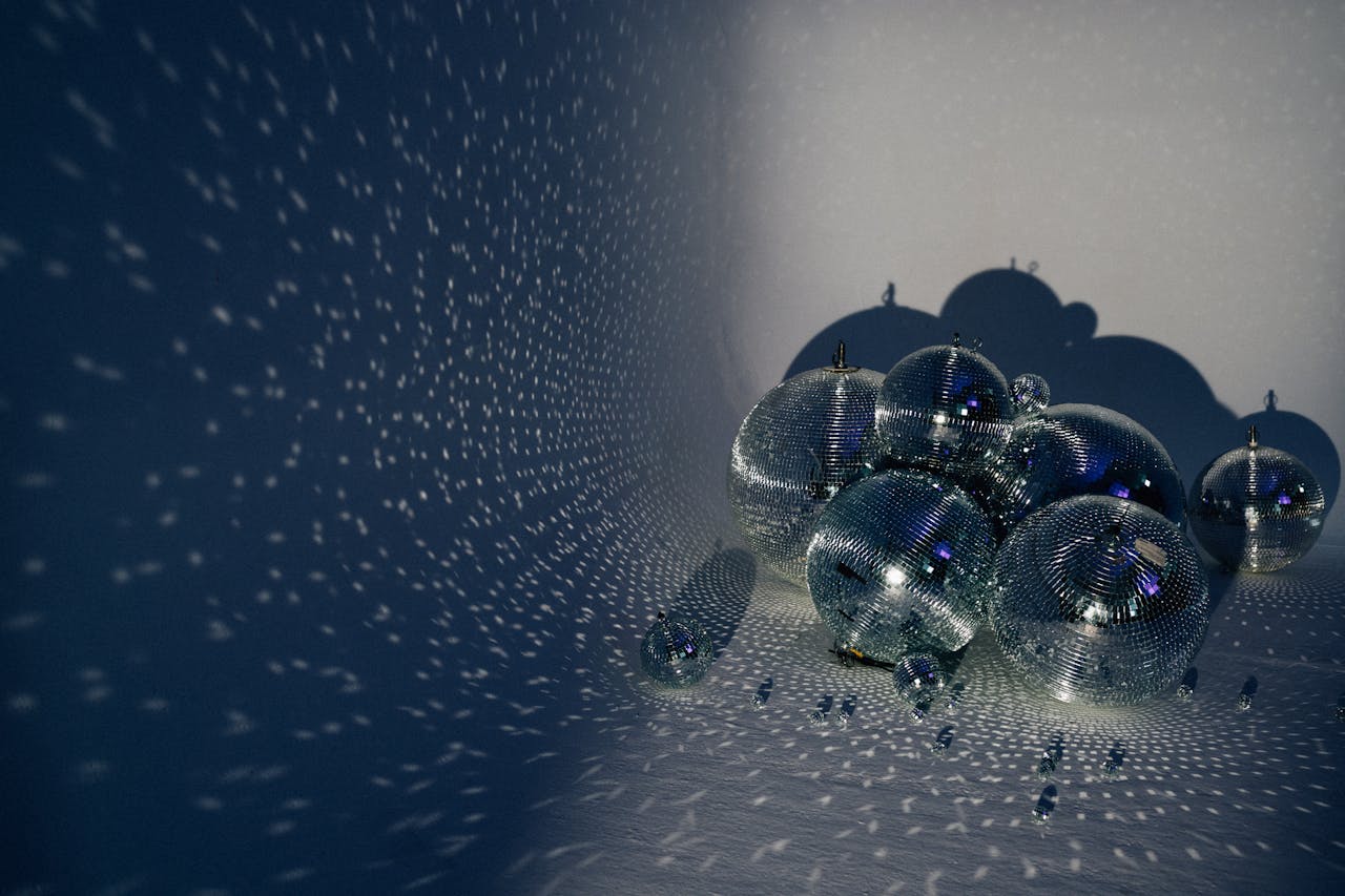 A creative studio shoot of shiny disco balls casting intricate patterns of light.